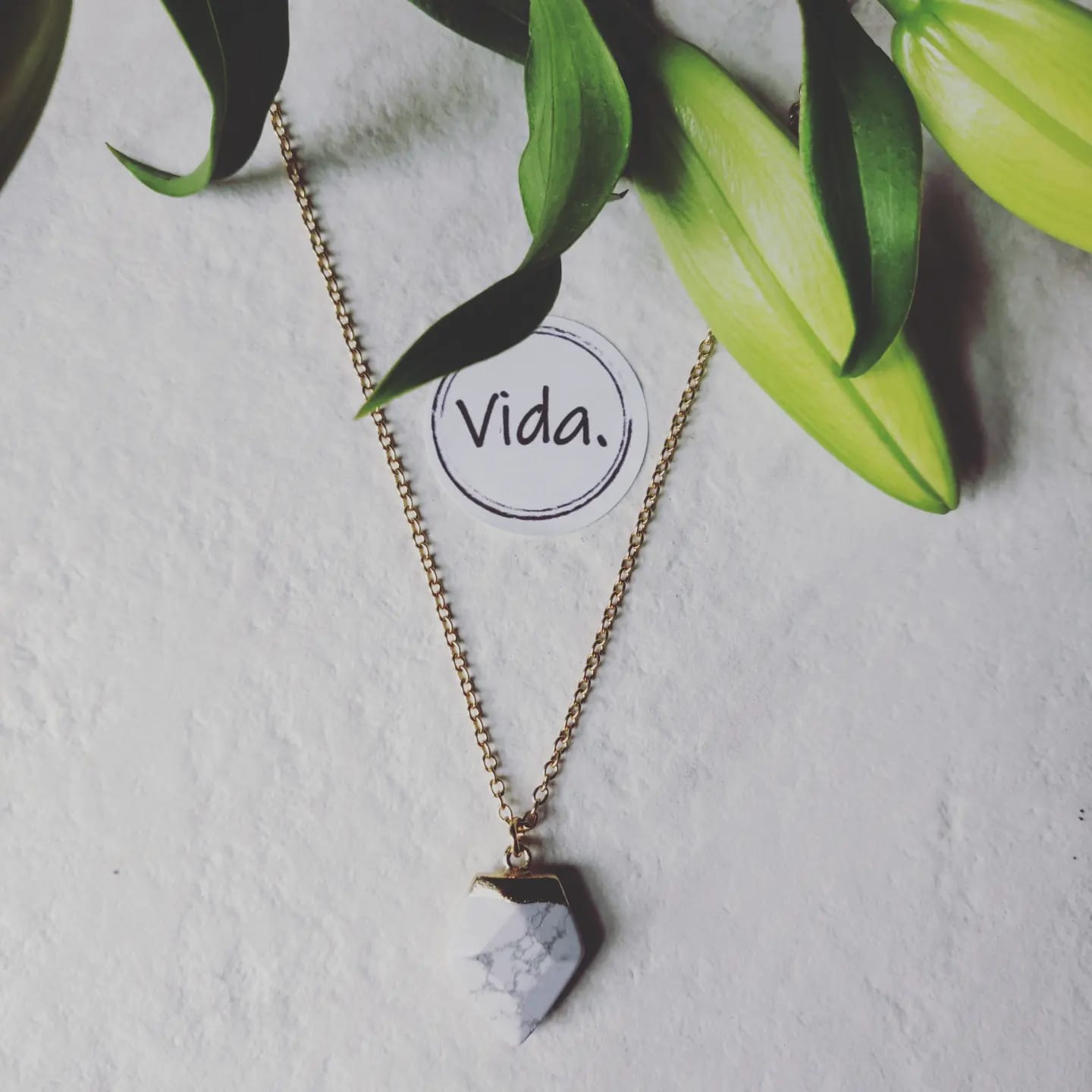 Howlite Crystal Arrow on Gold Tone Stainless Steel Necklace